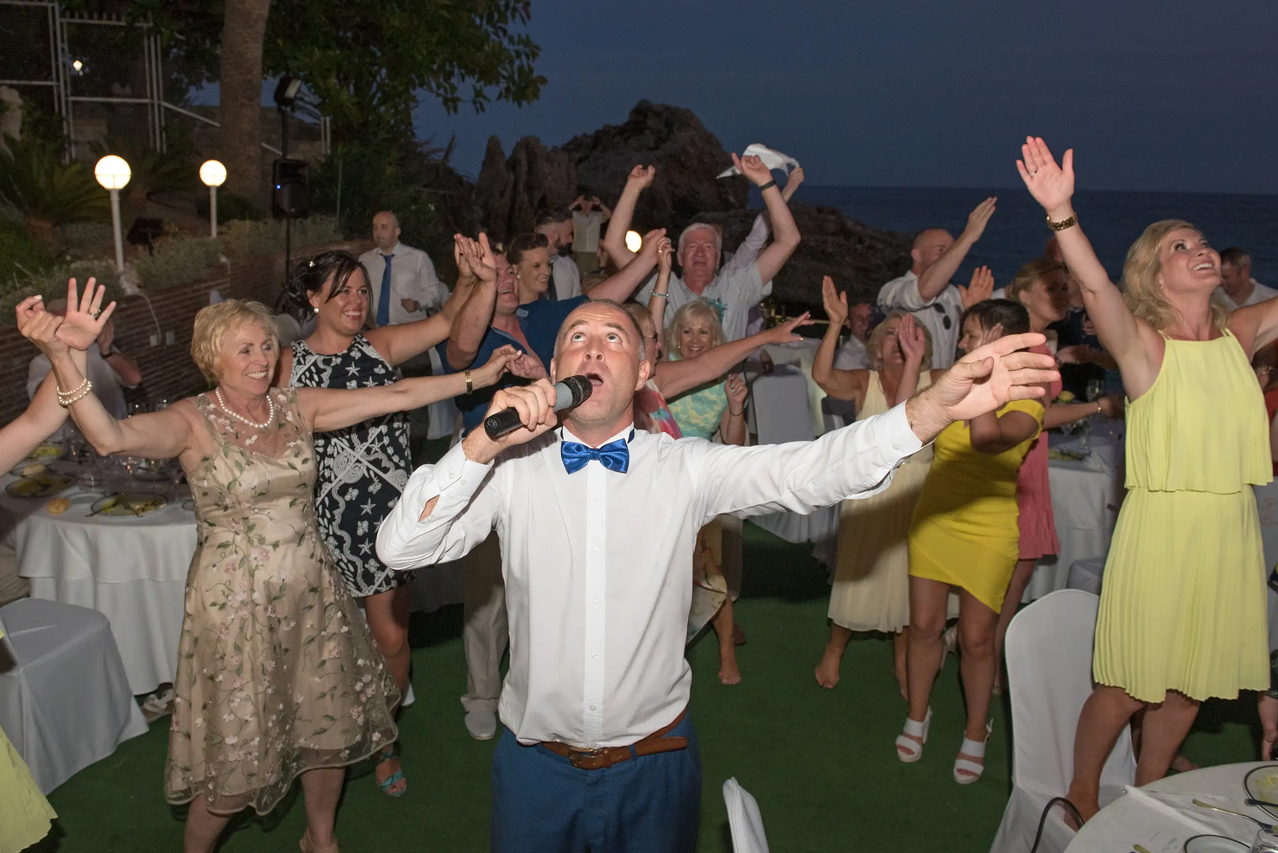 Couples and guests celebrating at a wedding hosted by Ian Preston